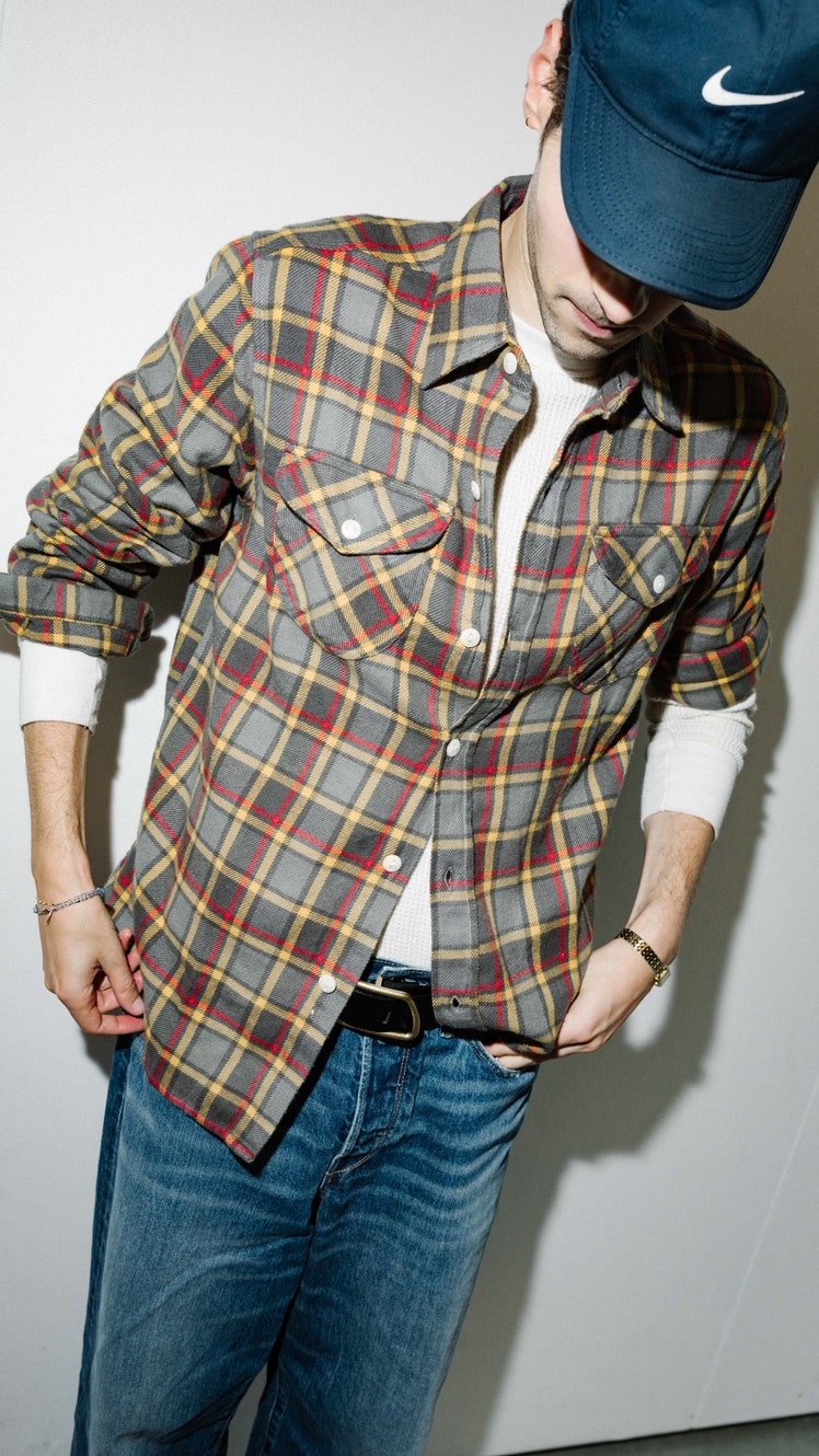 Image may contain Clothing Shirt Hat Pants Adult Person Sleeve Accessories Bracelet Jewelry Blazer and Coat
