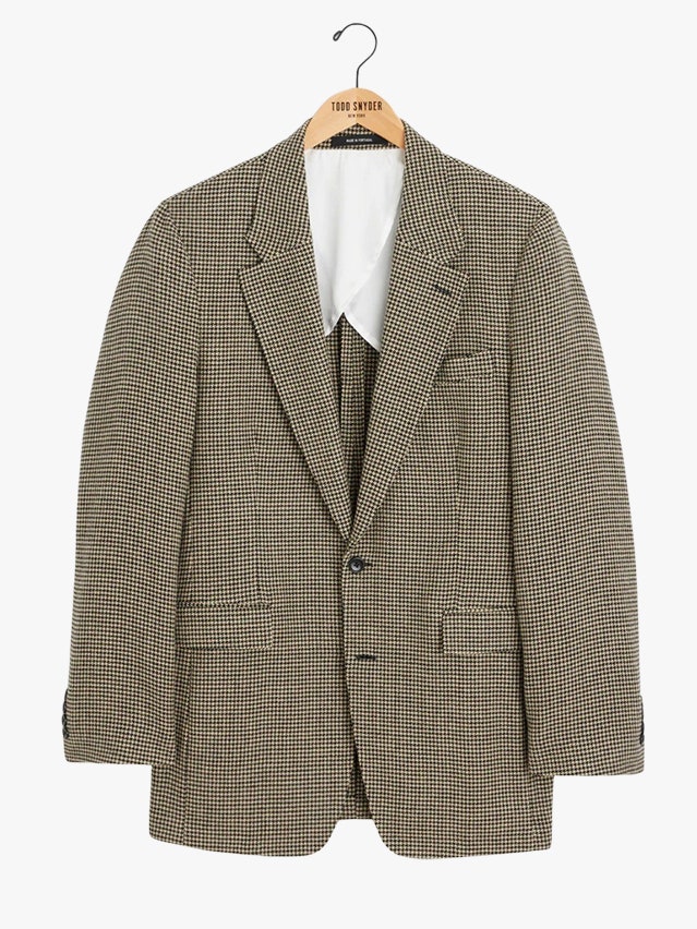 Image may contain Blazer Clothing Coat Jacket Formal Wear and Suit