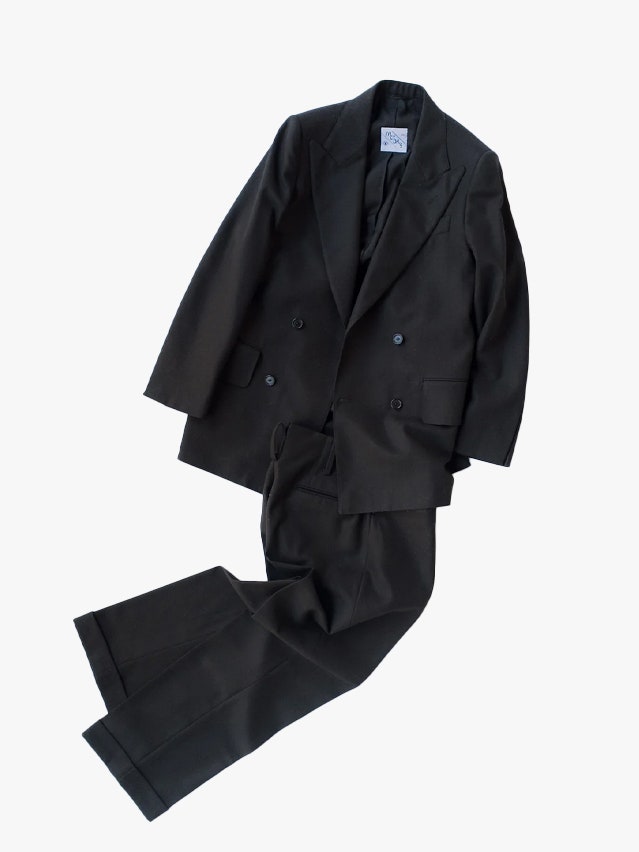 Image may contain Clothing Coat Blazer Jacket Formal Wear Suit and Pants