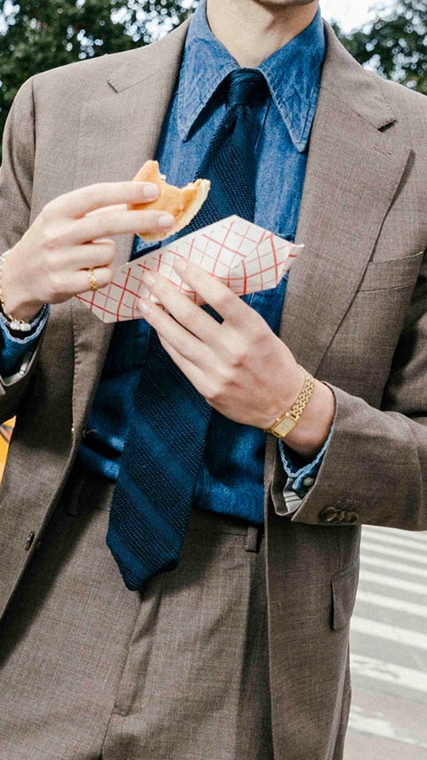 Image may contain Accessories Formal Wear Tie Jewelry Ring Clothing Coat Blazer Jacket Bread and Food